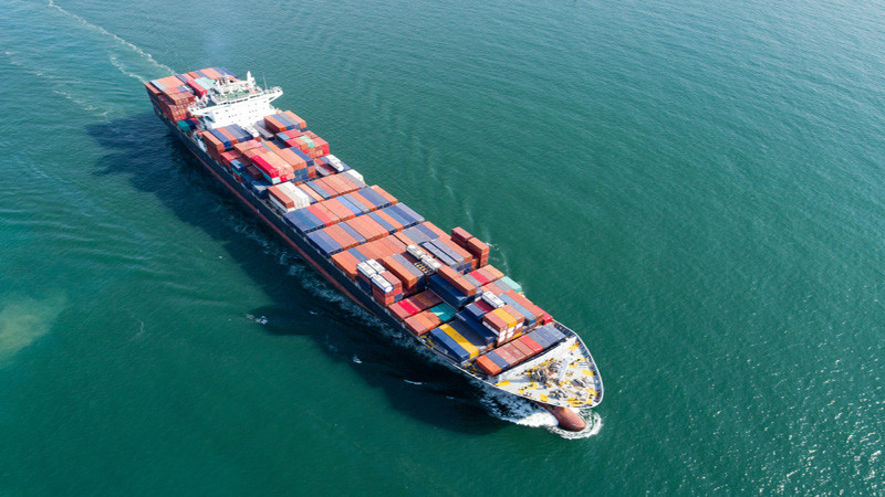 Container ship at sea, aerial view