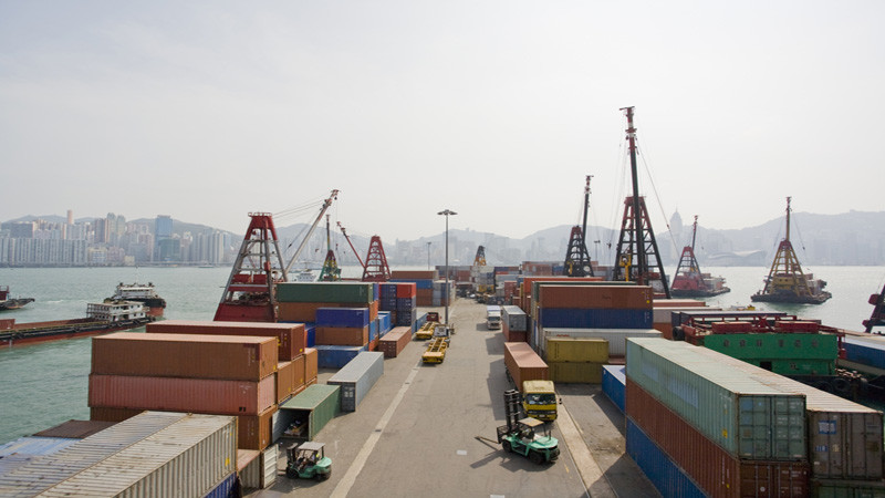 Workers unloading shipping containers