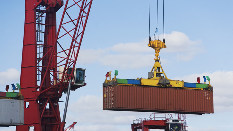 Crane lifting shipping container